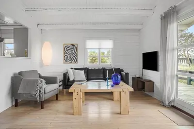 a living room with a couch and a table at LK1955-Lokken-Laurasvej-10 in Løkken