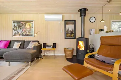 a living room with a couch and a fireplace at LK1354-Lokken-Madsinesvej-4 in Løkken
