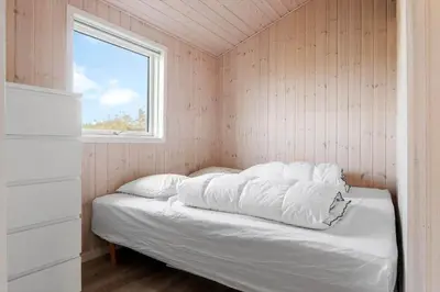 a bed in a small room with a window at LK2112-Lokken-Kettrup-Bjerge-Vej-64 in Løkken