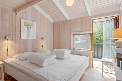 a bedroom with a bed with white pillows on it at LK1840-Lokken-Olgavej-32 in Løkken