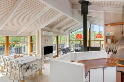 a kitchen and living room with a table and chairs at LK1840-Lokken-Olgavej-32 in Løkken