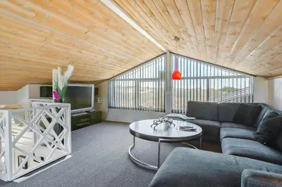 a living room with a couch and a table at LK855-Lokken-Monasvej-7 in Løkken