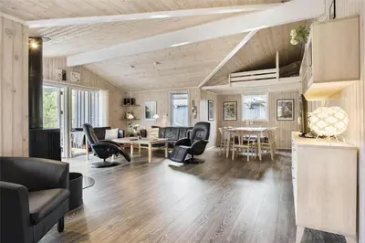 a living room with chairs and a dining room at LK1221-Lokken-Louisevej-5 in Løkken