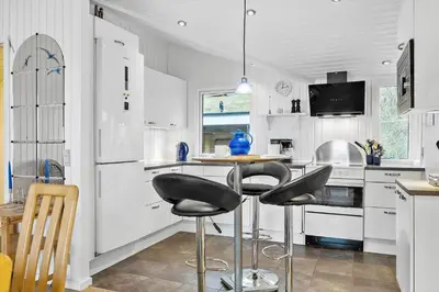 a kitchen with two chairs and a table in it at LK1958-Lokken-Kettrup-Bjerge-Vej-78-A in Løkken
