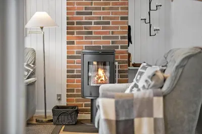 a fireplace in a living room with a fire in it at LK1958-Lokken-Kettrup-Bjerge-Vej-78-A in Løkken