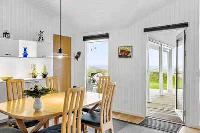 a kitchen and dining room with a table and chairs at LK1958-Lokken-Kettrup-Bjerge-Vej-78-A in Løkken