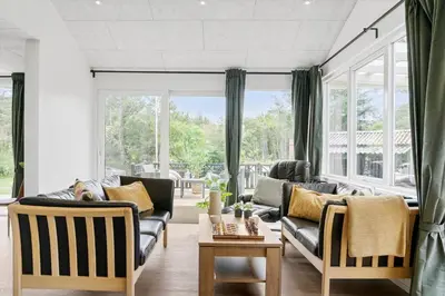 a living room with two couches and a table at BL1440-Blokhus-Moreavej-2 in Blokhus