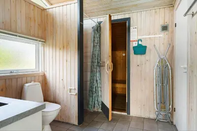 a bathroom with a toilet and a shower at LK850-Lokken-Jorginesvej-8 in Løkken