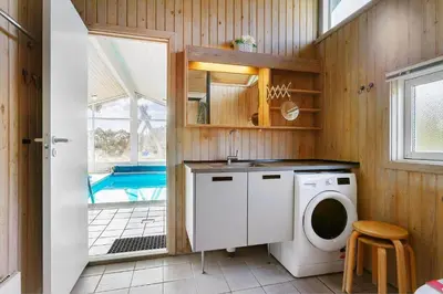 a bathroom with a washing machine and a pool at LK850-Lokken-Jorginesvej-8 in Løkken