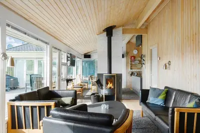 a living room with leather furniture and a fireplace at LK850-Lokken-Jorginesvej-8 in Løkken