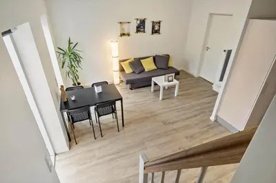 a living room with a couch and a table at BL1583-Blokhus-Strandvejen-14-Lejl-12 in Blokhus