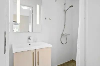 a white bathroom with a sink and a shower at BL1583-Blokhus-Strandvejen-14-Lejl-12 in Blokhus