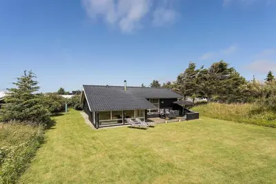 a house with a large yard in front of it at BL1201-Blokhus-Stromsvej-1 in Blokhus