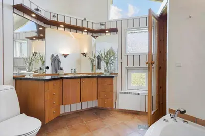 a bathroom with a toilet and a sink at BL1201-Blokhus-Stromsvej-1 in Blokhus