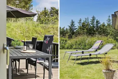 a patio with a table and chairs and an umbrella at BL1201-Blokhus-Stromsvej-1 in Blokhus