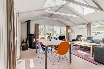 a living room with a dining room table and chairs at LK504-Lokken-Kristavej-23 in Løkken