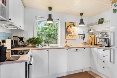 a kitchen with white cabinets and a window at BL339-Pandrup-Skorr-Karensvej-5 in Pandrup
