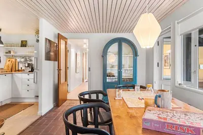 a kitchen and dining room with a wooden table and chairs at BL339-Pandrup-Skorr-Karensvej-5 in Pandrup
