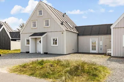 a large white house with a black roof at BL1478-Blokhus-Ferren-Syd-152 in Blokhus