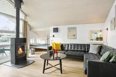 a living room with a couch and a fireplace at BL1736-Blokhus-Slettevej-3 in Blokhus