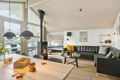 a living room with a couch and a fireplace at BL1736-Blokhus-Slettevej-3 in Blokhus