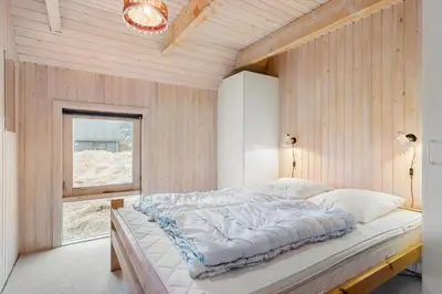 a large bed in a room with a window at BL1469-Pandrup-Grinden-6 in Pandrup