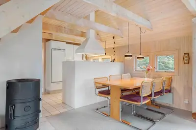 a dining room with a table and a trash can at BL1469-Pandrup-Grinden-6 in Pandrup