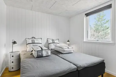 a bedroom with two beds and a window at BL1535-Blokhus-Saetergaardsstien-5-A in Blokhus