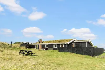 a house with a grass roof sitting on top of a field at LK1947-Lokken-Madsinesvej-11 in Løkken