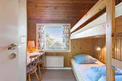 a small bedroom with a bunk bed and a desk at LK1947-Lokken-Madsinesvej-11 in Løkken