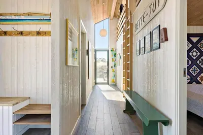 a hallway of a house with a green bench at BL1679-Blokhus-Gormsvej-33 in Blokhus