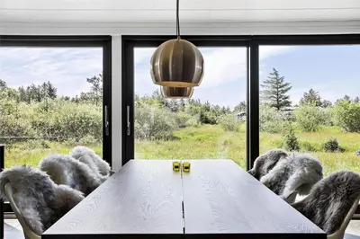 a dining room with a white table and a large window at BL1642-Saltum-Bondagervej-50 in Saltum