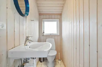 a bathroom with a sink and a toilet at LK611-Lokken-Rosavej-9 in Løkken