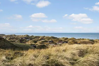 a group of houses on the rocks near the ocean at LK611-Lokken-Rosavej-9 in Løkken