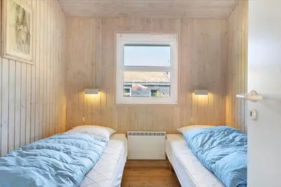 a bedroom with two beds and a window at BL368-Blokhus-Bag-Hojen-19 in Blokhus
