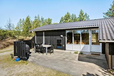 a house with a patio with a table and chairs at BL1789-Saltum-Krogsletten-20 in Saltum