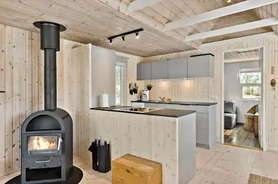 a kitchen with a wood stove in a room at BL1789-Saltum-Krogsletten-20 in Saltum