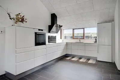 a kitchen with white cabinets and a sink at BL1611-Saltum-Trehoje-3 in Saltum