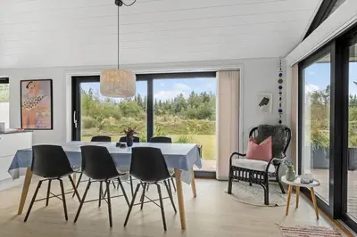 a dining room with a table and chairs at BL1635-Blokhus-Lyngdraget-19 in Blokhus