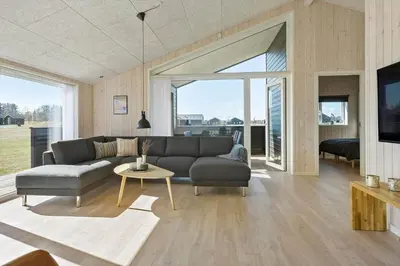 a living room with a couch and a table at LK2031-Lokken-Kringelbaekvej-55 in Løkken