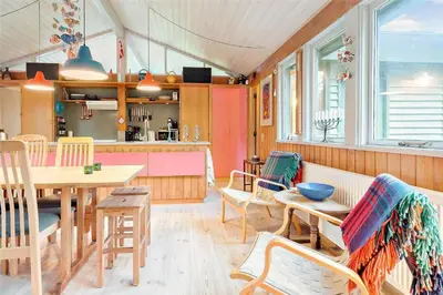 a kitchen and dining room with a table and chairs at BL128-Saltum-Klaus-Bjergsvej-9 in Saltum