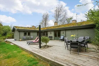 a deck with a table and chairs and a house at BL128-Saltum-Klaus-Bjergsvej-9 in Saltum