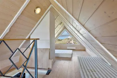 an attic room with a staircase in a house at BL116-Saltum-Revlingevej-44 in Saltum