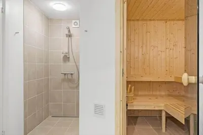 a bathroom with a shower with a wooden shower stall at BL116-Saltum-Revlingevej-44 in Saltum