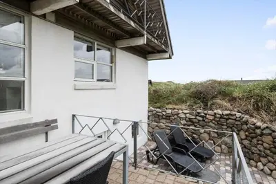 a porch with a bench and a rock wall at BL116-Saltum-Revlingevej-44 in Saltum
