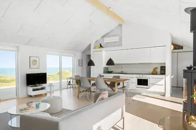 a living room with a couch and a table at LK553-Lokken-Rosavej-7 in Løkken