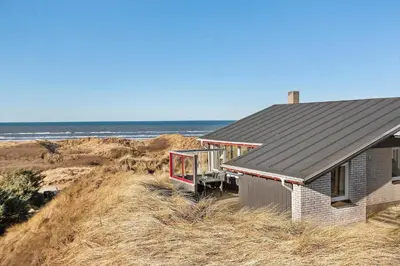 a house on a hill next to the ocean at LK2130-Lokken-Lottesvej-23 in Løkken