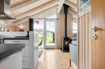 a kitchen with a door open to a living room at BL416-Saltum-Revlingevej-28 in Saltum