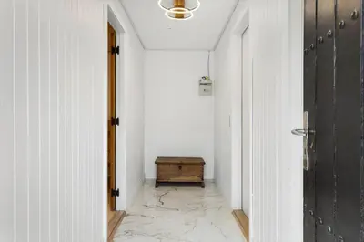 an empty hallway with a table in a room at LK2117-Lokken-Kettrup-Bjerge-Vej-55 in Løkken