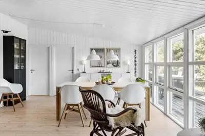 a kitchen and dining room with a table and chairs at BL1598-Blokhus-Raevestien-2 in Blokhus